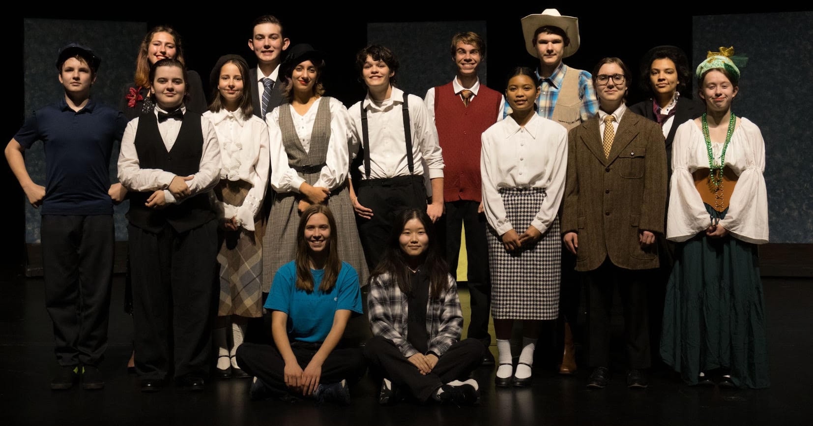 Drama Fest cast group photo on stage in costume